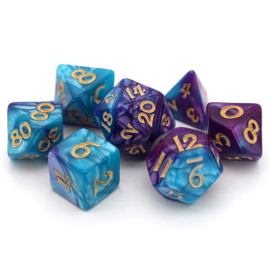 Sky Shadow is a 7-piece, 13mm polymer set of swirled blue and purple acrylic dice, inked in gold. It belongs to our tiny but mighty Wee Lads collection. Standard d20 pictured for scale.