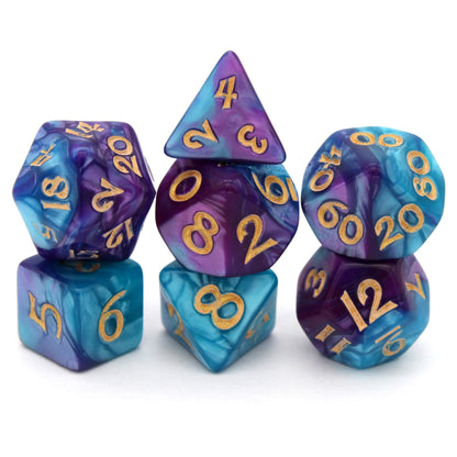 Sky Shadow is a 7-piece, 13mm polymer set of swirled blue and purple acrylic dice, inked in gold. It belongs to our tiny but mighty Wee Lads collection. Standard d20 pictured for scale.
