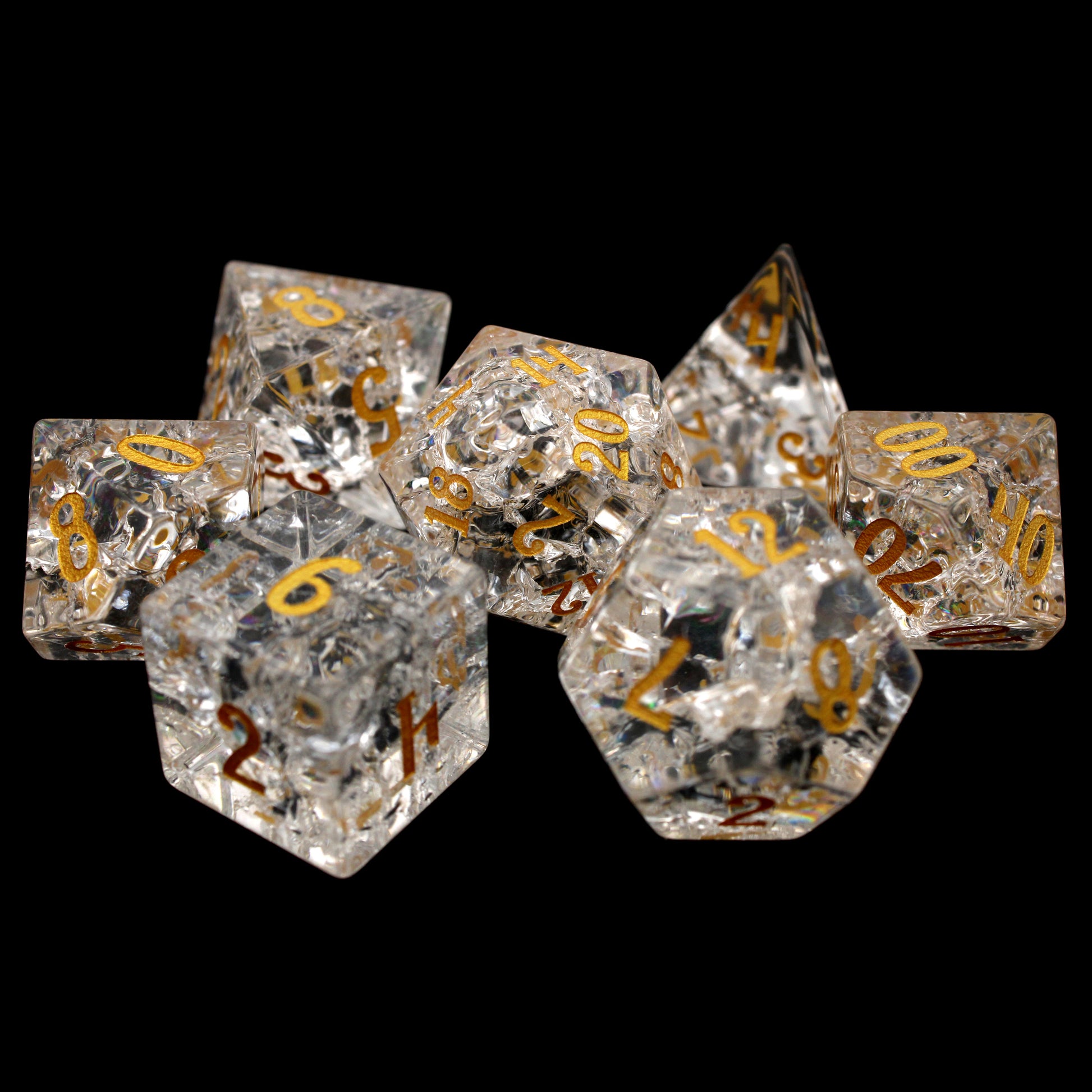 Stardust is a 7-piece set of clear crystal dice with a crackle effect and gold inked numbers.