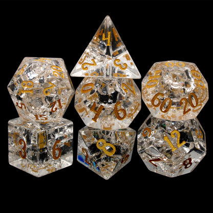 Stardust is a 7-piece set of clear crystal dice with a crackle effect and gold inked numbers.