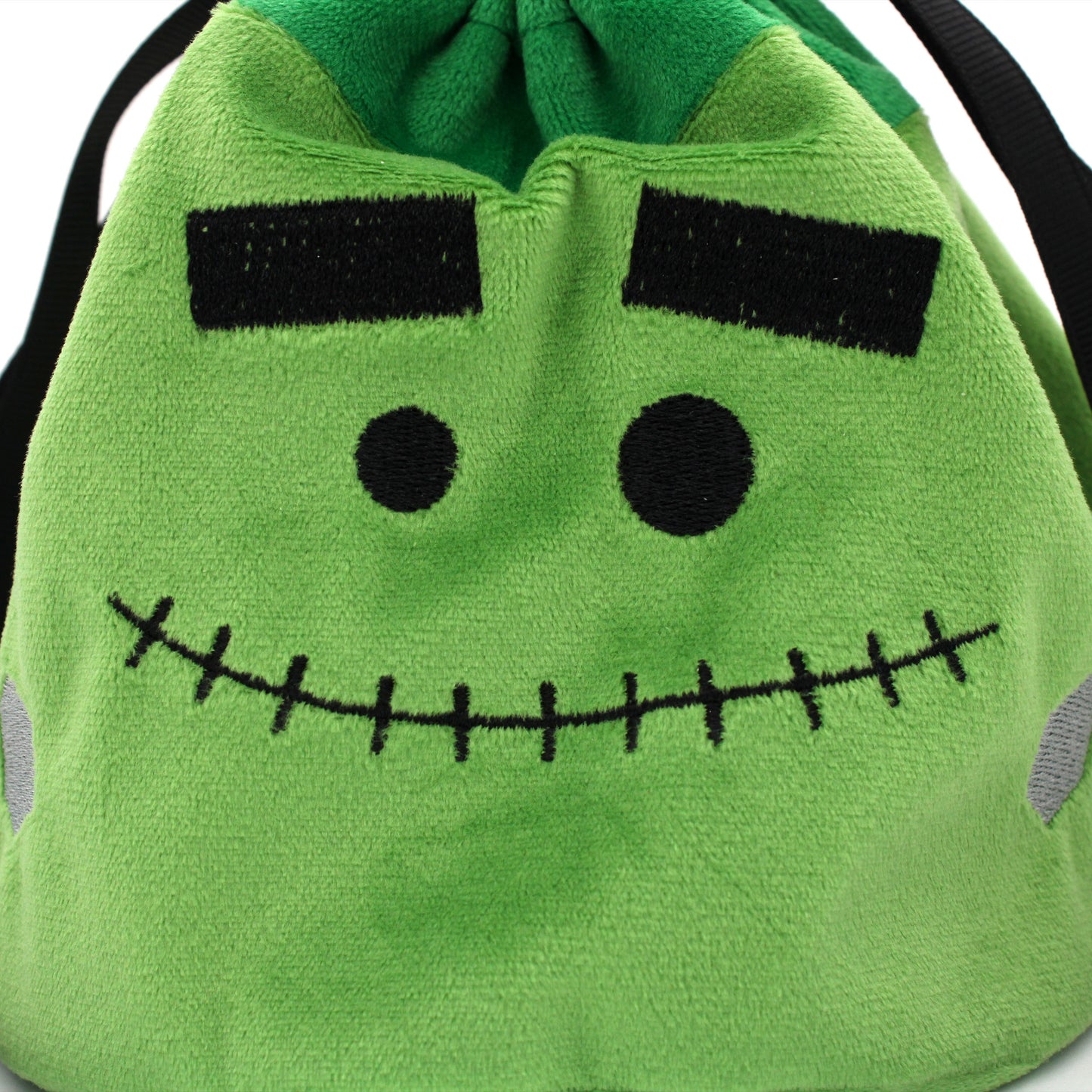 Each Trick or Treat Mystery Bag contains a selection of spooky delights, including 3 full sets of dice, as well as an assortment of goodies, all held in a plush Franken-pouch.