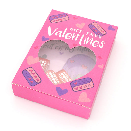 Each box of Valentines contains nine tabletop-themed cards, nine red Infinity d4s with our Pixel Heart design in white ink, as well as nine adhesives to affix the dice to the cards, all held in a pink printed package.