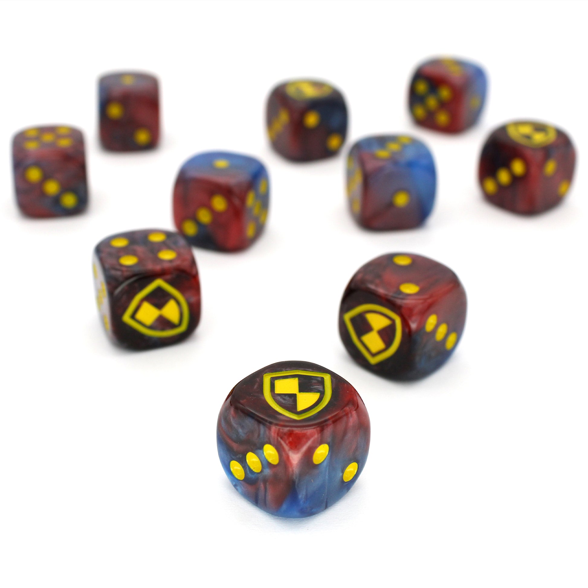 War Shield (Empire) is a 10-piece set of 16mm polymer d6s in red and blue, with pips and shield engraving in yellow ink. It is part of our Fantasy Squads series of dice for miniature wargaming.