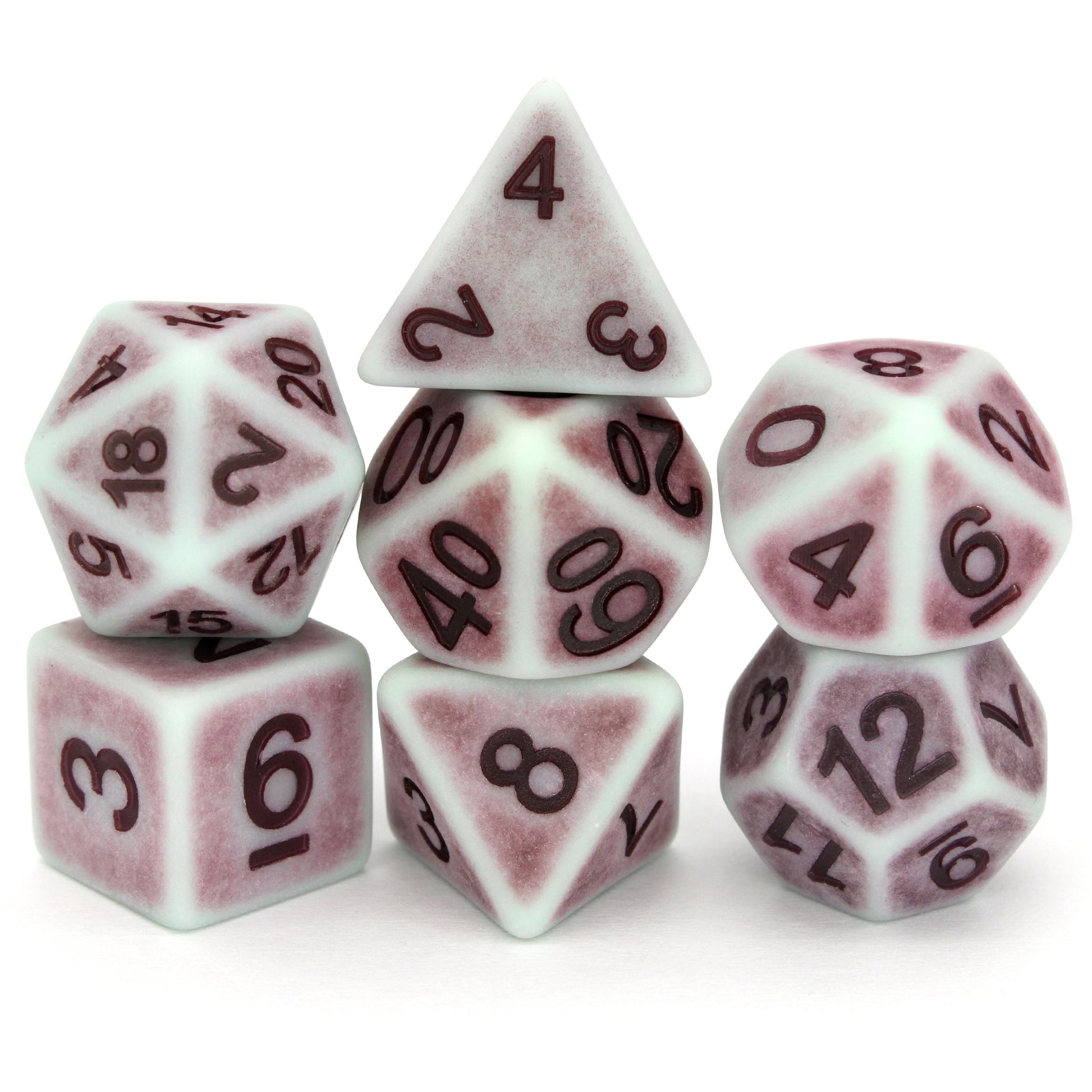 Whistle Past the Grapeyard is a 7-piece set of matte, pale-colored dice with a lavender patina, inked in purple.
