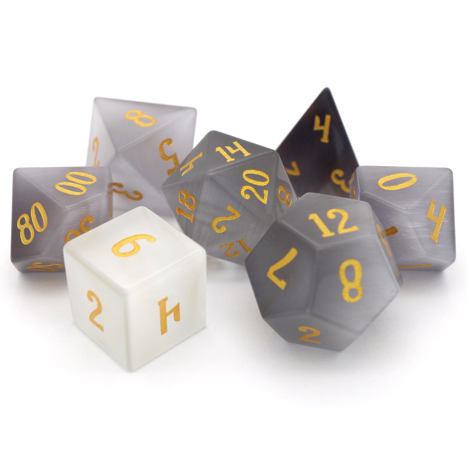 Winterfest is a 7-piece set of wintery white cat's eye crystal dice with gold numbering.