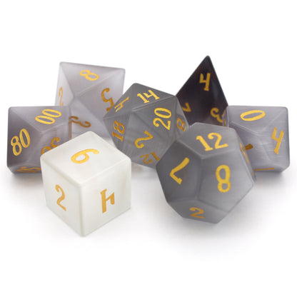 Winterfest is a 7-piece set of wintery white cat's eye crystal dice with gold numbering.