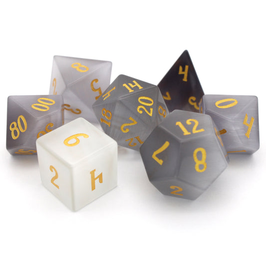 Winterfest is a 7-piece set of wintery white cat's eye crystal dice with gold numbering.