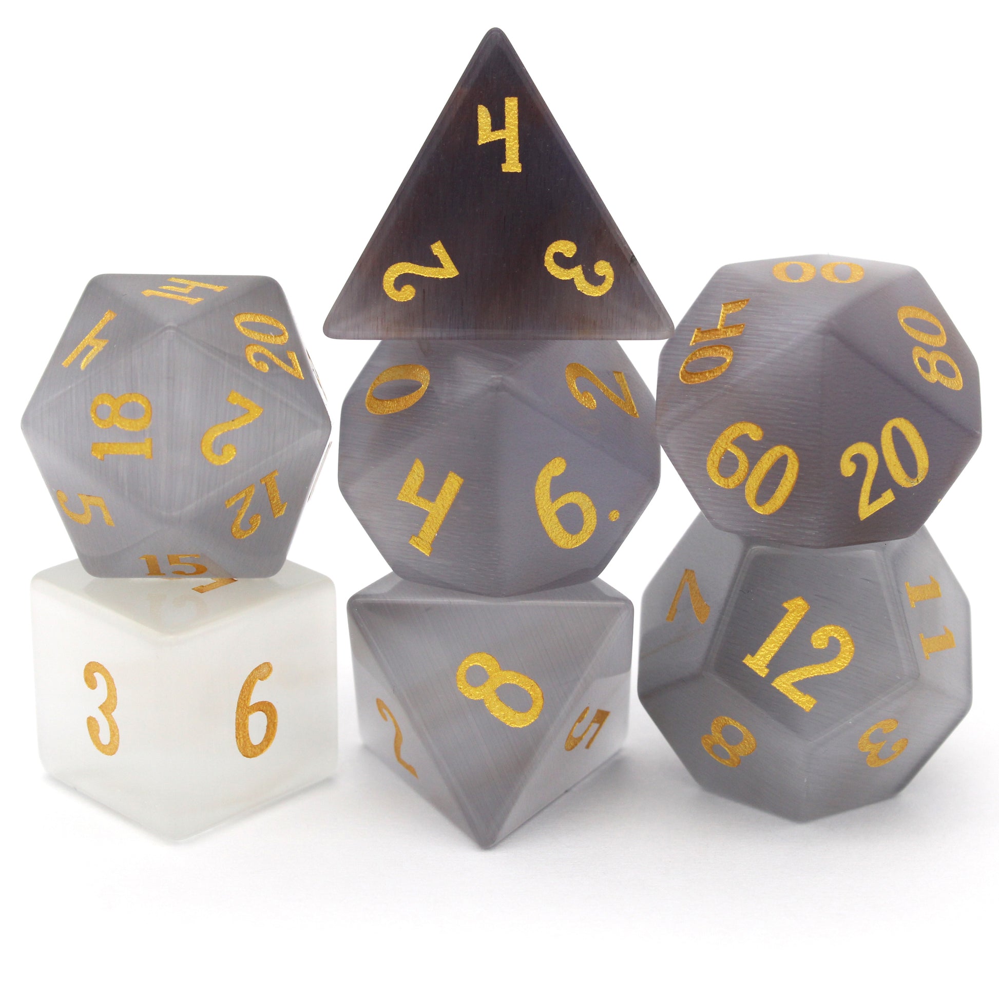 Winterfest is a 7-piece set of wintery white cat's eye crystal dice with gold numbering.