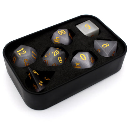 Winterfest is a 7-piece set of wintery white cat's eye crystal dice with gold numbering.