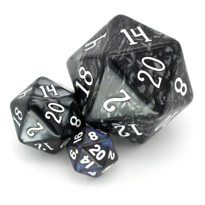 Witching Hour is a 7-piece, 13mm, dark grey resin dice set featuring color-shifting indigo-purple micro glitter, inked in white.