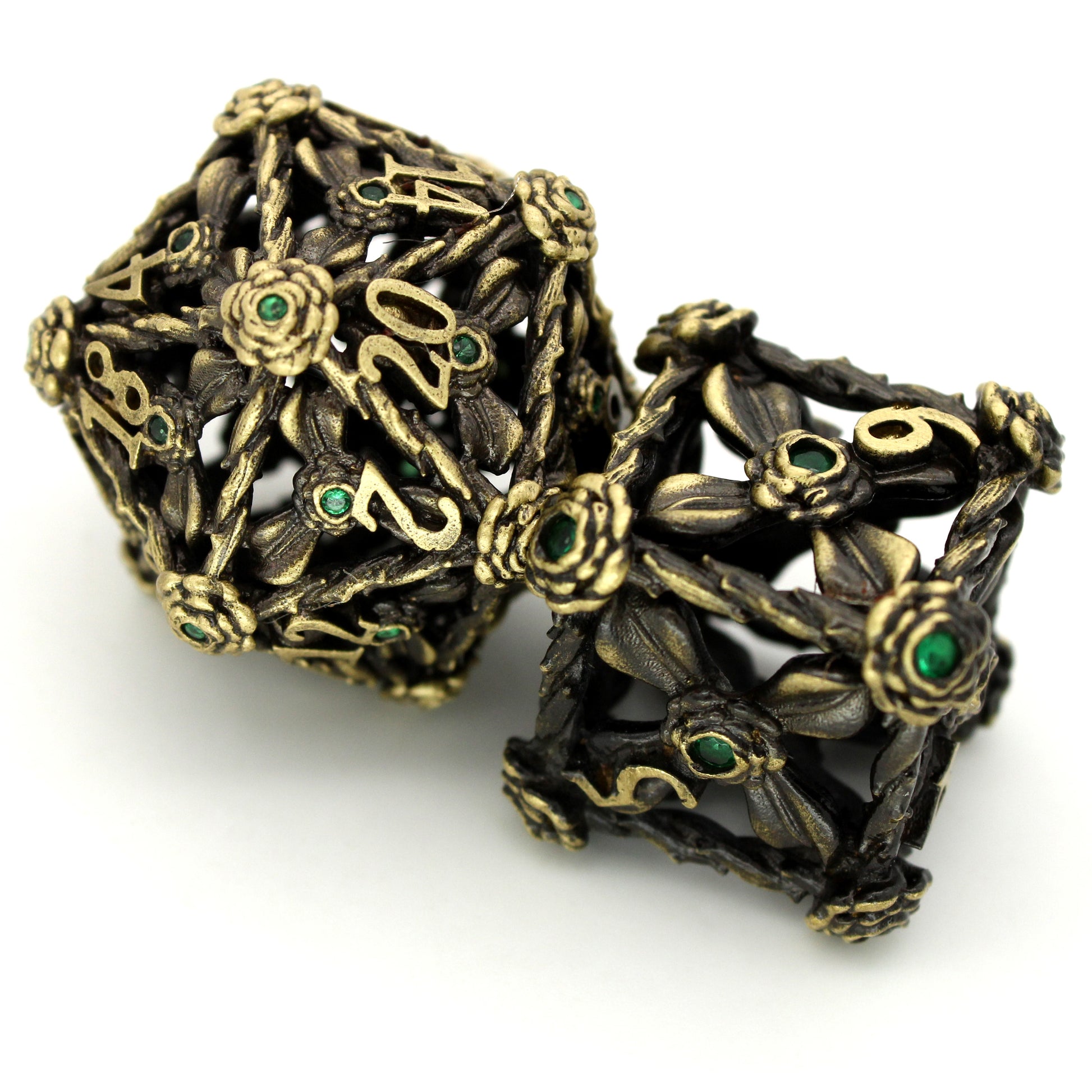 Wither and Bloom is a 7-piece set of hollow brass dice featuring flowers, vines, and tiny green gems.
