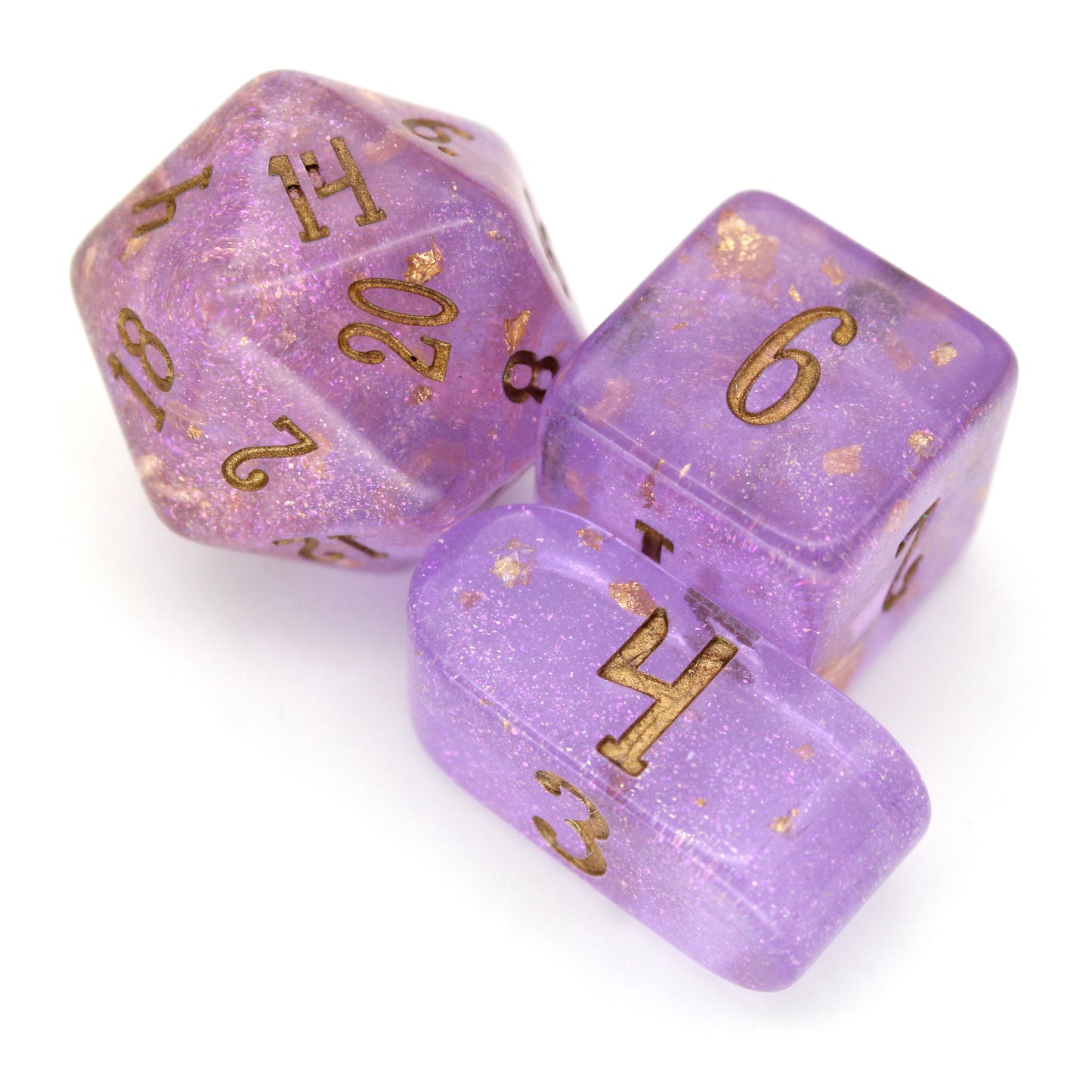 Wizard's Weave is a 10-piece set of translucent, glittery, purple resin dice sprinkled with gold foil and inked in bronze.