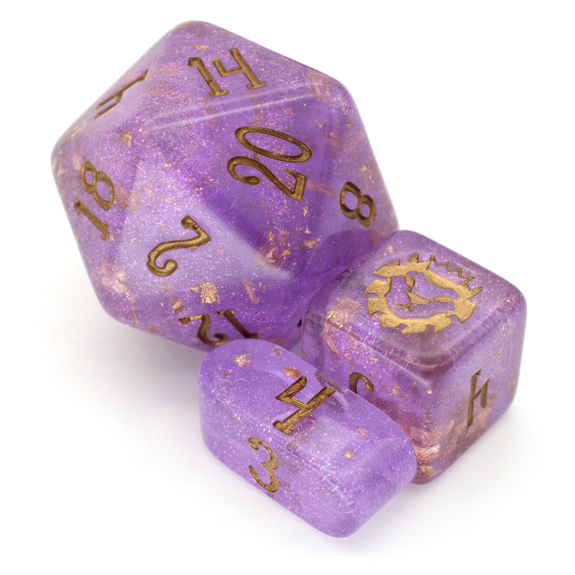 Wizard's Weave is a 10-piece set of translucent, glittery, purple resin dice sprinkled with gold foil and inked in bronze.