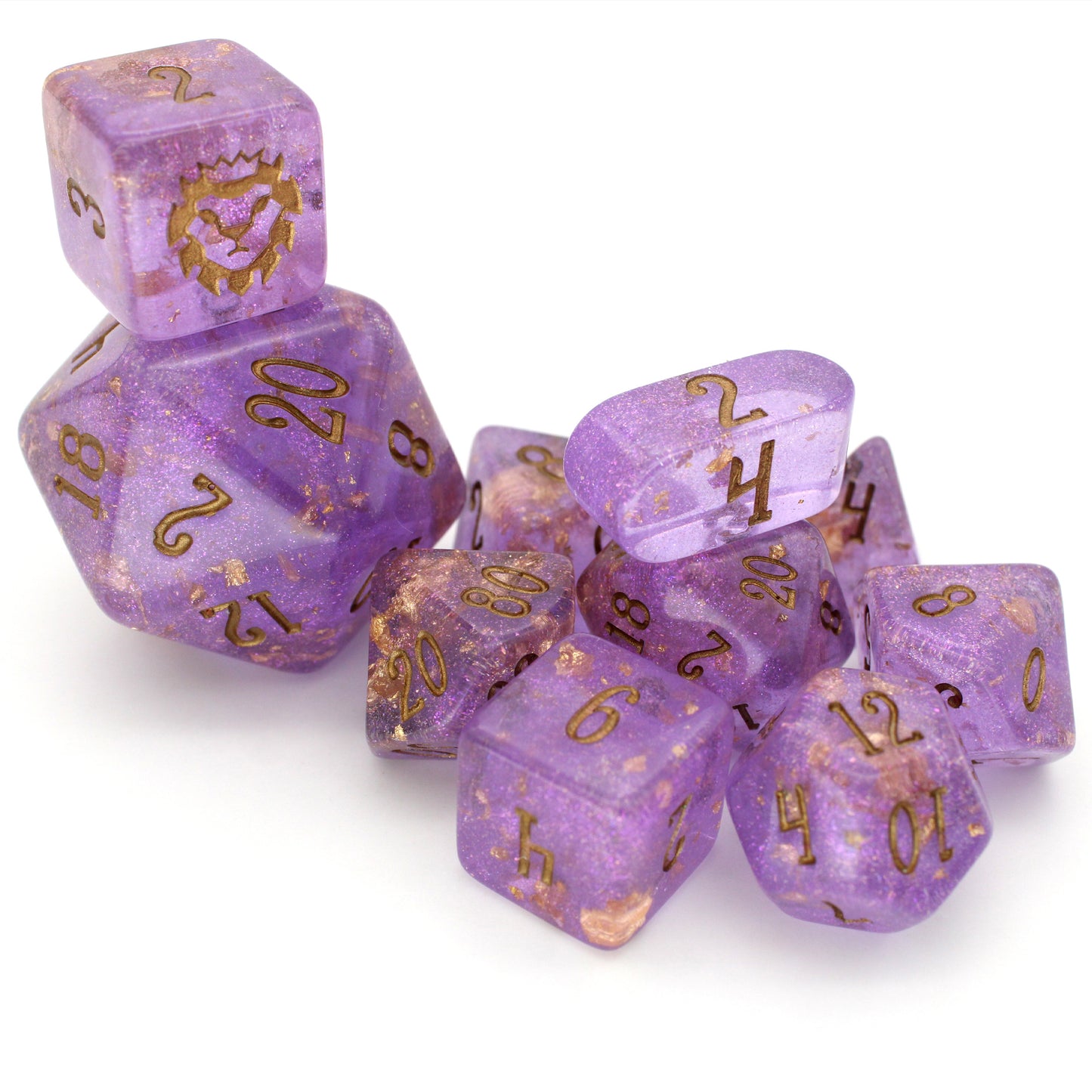 Wizard's Weave is a 10-piece set of translucent, glittery, purple resin dice sprinkled with gold foil and inked in bronze.