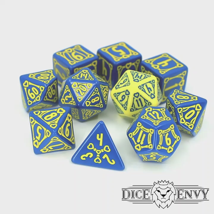 Holy Crit is an engraved 10-piece set of blue resin dice inked in neon yellow and features 3d6’s, as well as a color-swapped d20 for advantage.