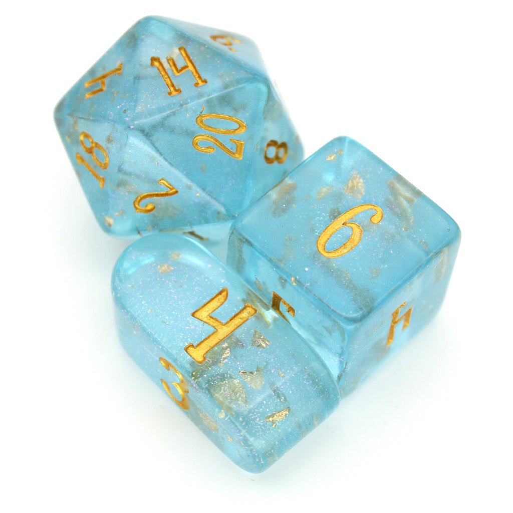 Celesteal is a bright blue 10-piece resin set with gold flake inclusions, pink micro glitter, and gold ink.