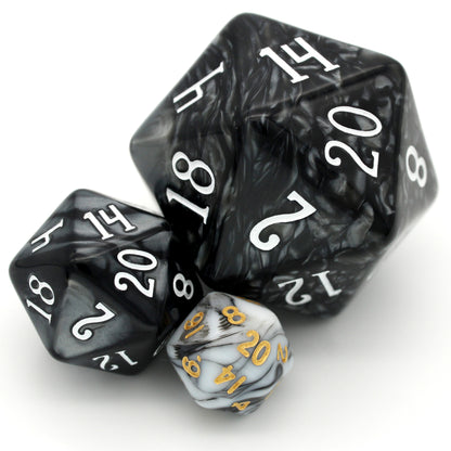 D'lites is a 7-piece 13mm resin dice set with swirls of black and white, inked in pale gold. It belongs to our tiny but mighty Wee Lads collection.