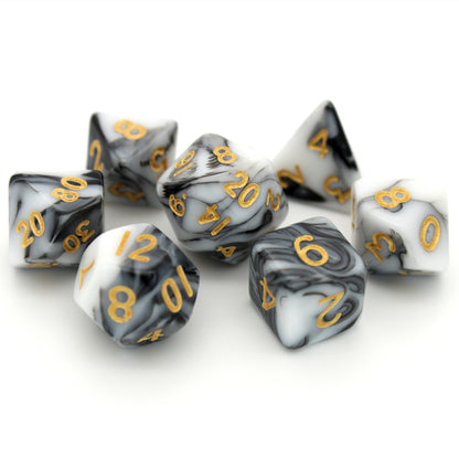 D'lites is a 7-piece 13mm resin dice set with swirls of black and white, inked in pale gold. It belongs to our tiny but mighty Wee Lads collection.