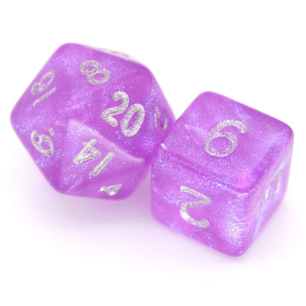Fuchsia Past is a 7-piece 13mm semi-translucent glittery fuchsia resin dice set, inked in silver. It belongs to our tiny but mighty Wee Lads collection.