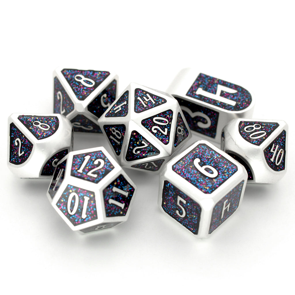 Hanabi - Heist Edition is a 7-piece silver metal dice set inlaid with glittery cosmic enamel. This special edition features a Dice Envy exclusive Infinity d4.