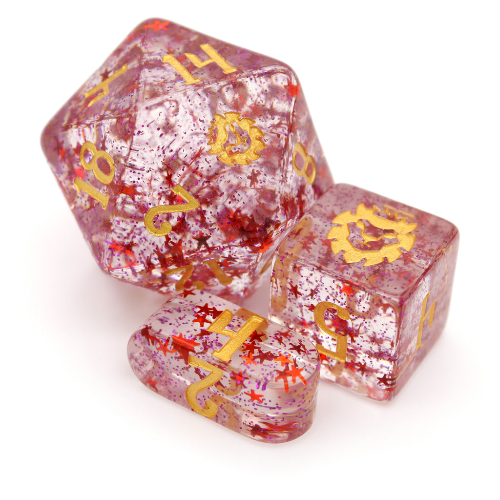 Hypnotic Pattern is a red and purple shifting glitter 10-piece resin set with holographic stars, inked in gold.