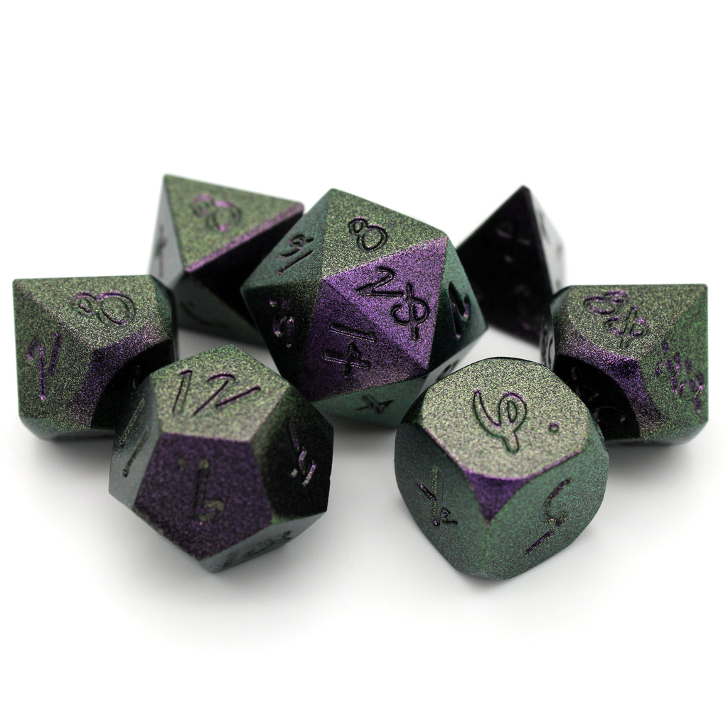 Mage Hand Sorcerer's Grasp is a 7-piece, green-and-purple-shifting metal set featuring Aabria Iyengar's handwritten numbers.