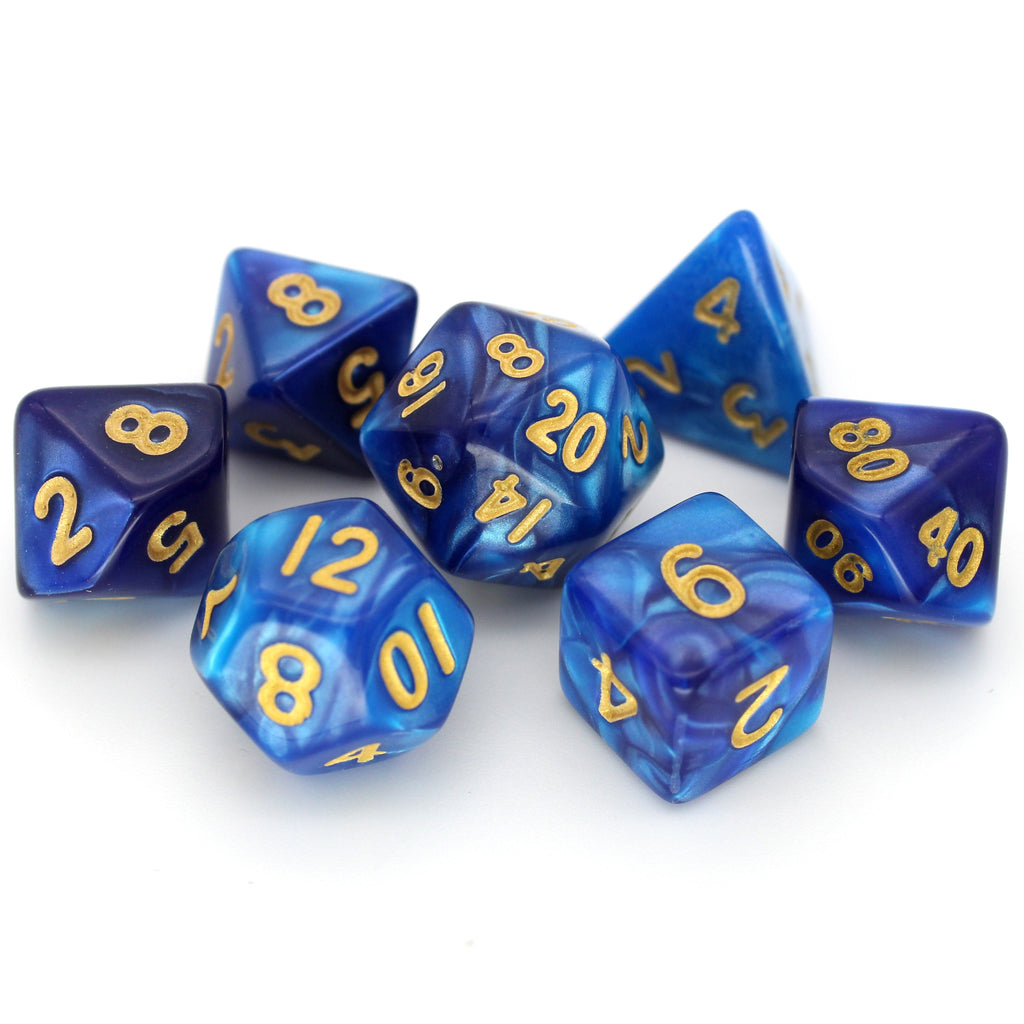 Mblue is a 7-piece 13mm resin dice set with shimmering waves of pearlescent blue, inked in pale gold. It belongs to our tiny but mighty Wee Lads collection.