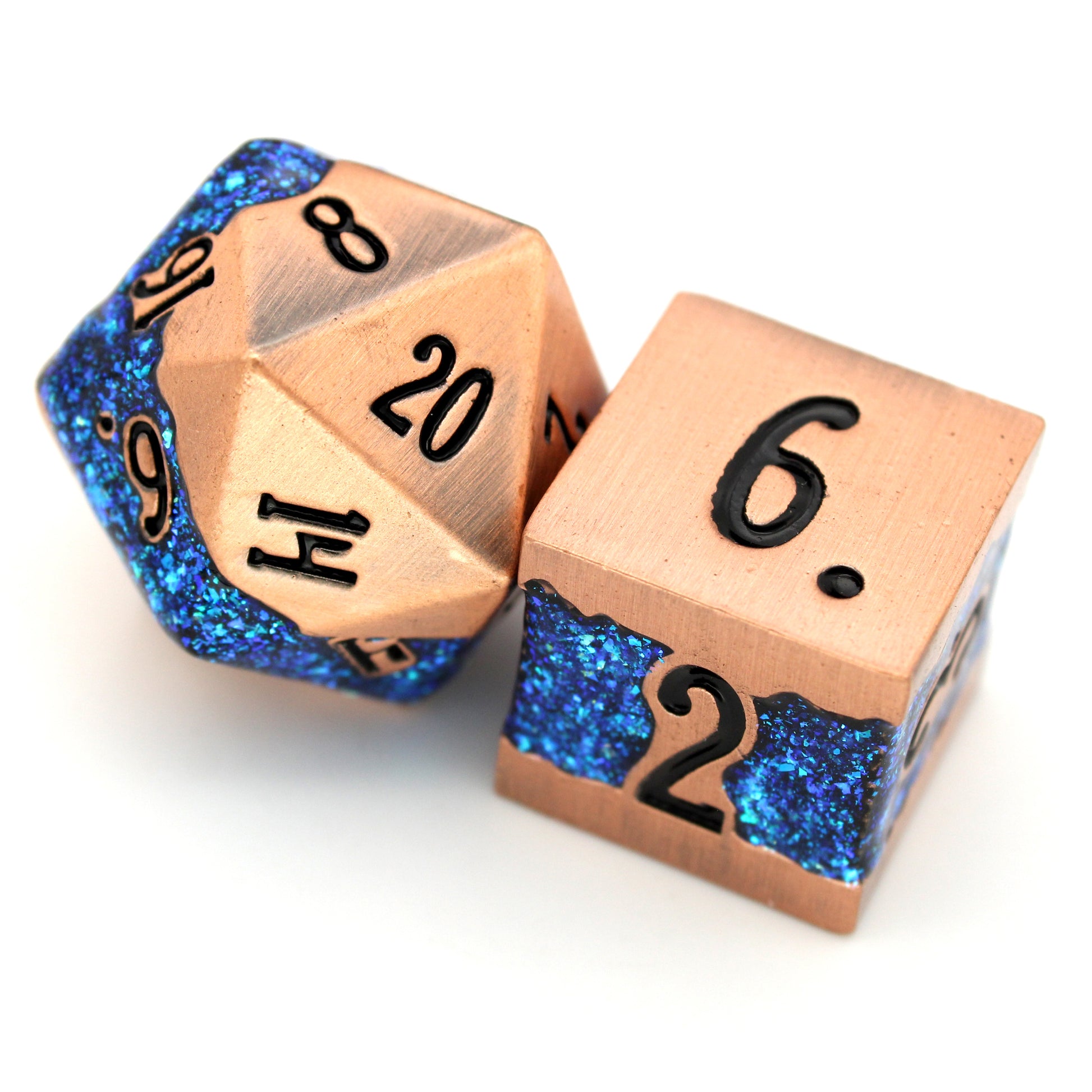 Rolling River is a 7-piece metal dice set with a rich copper frame and brilliantly glittering teal-blue enamel.