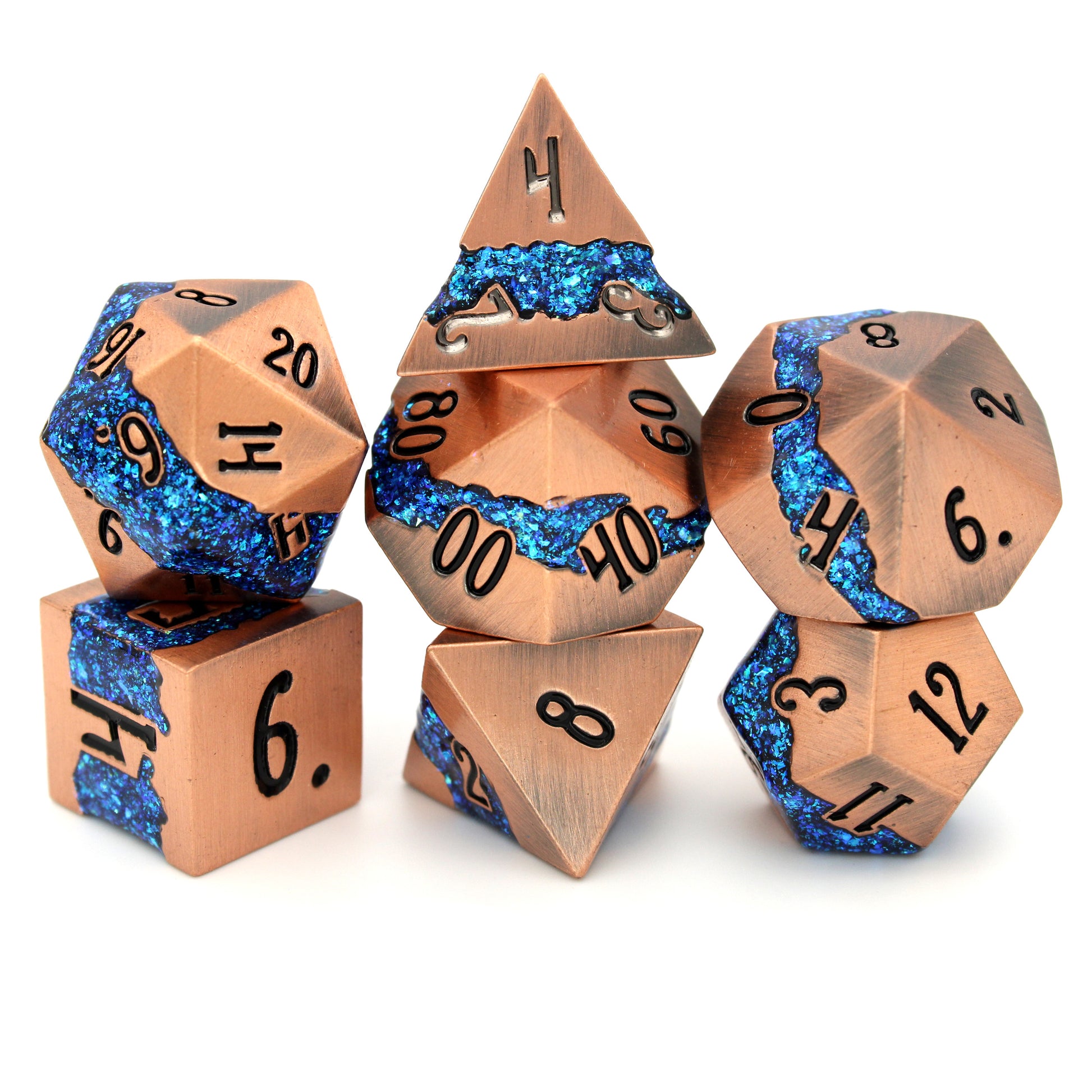 Rolling River is a 7-piece metal dice set with a rich copper frame and brilliantly glittering teal-blue enamel.