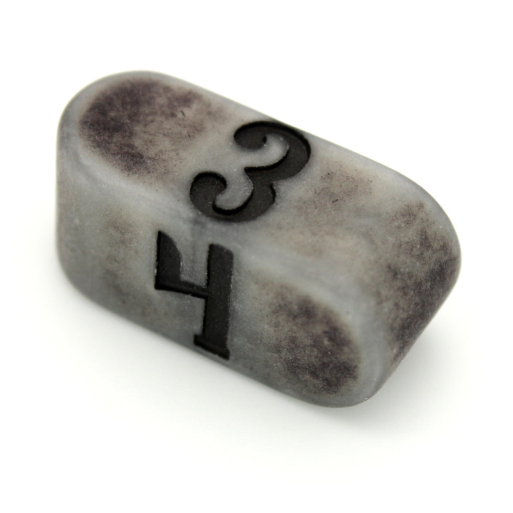 Tombstone Infinity is a stone-colored acrylic Infinity d4 with a matte finish and darkened pattern.
