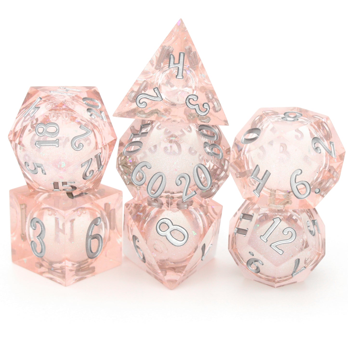 Unicorn Daydreams is a 7-piece, translucent light pink, sharp edge resin dice set with a liquid core of color-shifting pearlescent glitter, inked in silver.