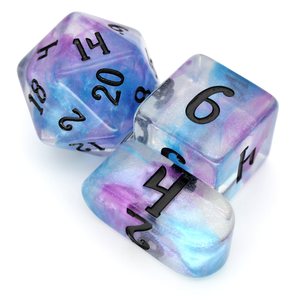 Will-O-Wisp is a 10-piece clear resin dice set with iridescent microglitter and rare pearlescent wisps of blue and purple swirls.